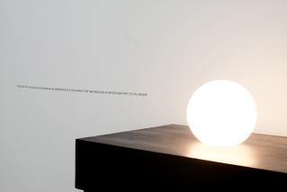 Iman Issa, Material for a sculpture proposed as an alternative to a monument that has become an embarrassment to its people, two light bulbs, dark walnut plywood table, 2010Photo: Serkan Taycan, Courtesy Iman Issa and Rodeo, Istanbul / London
